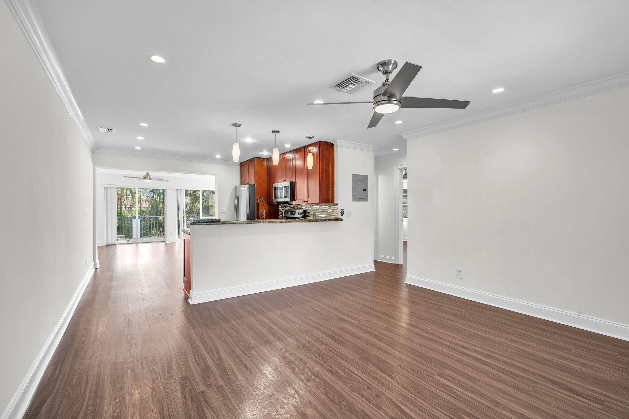 144 Northwest 4th Avenue Boca Raton, FL 33432 - Photo 9 of 35 a view of a kitchen with wooden floor and window