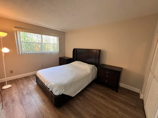 a bedroom with a bed and window