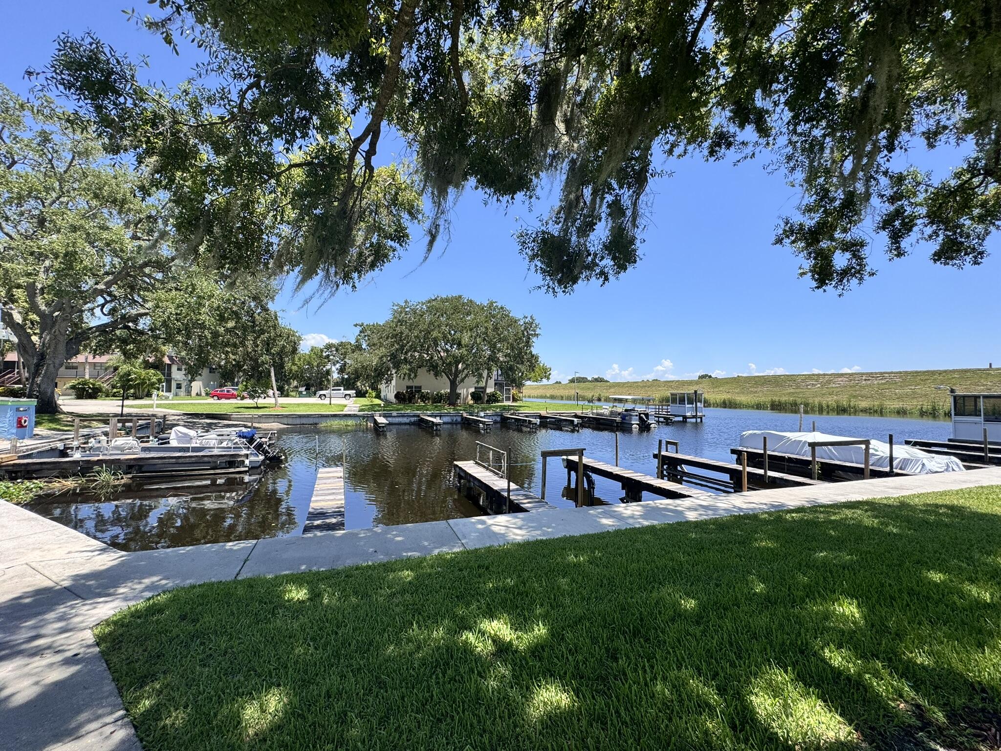 3124 Highway 441, Unit J1 Okeechobee, FL 34974 - Photo 32 of 40 a view of a lake with houses in the back