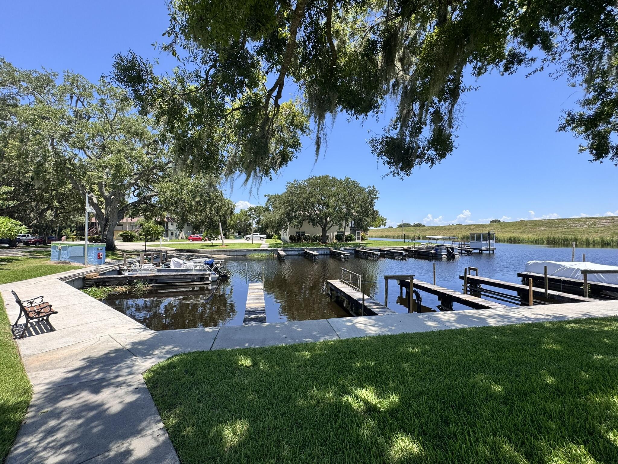 3124 Highway 441, Unit J1 Okeechobee, FL 34974 - Photo 33 of 40 a view of a lake with houses in the back
