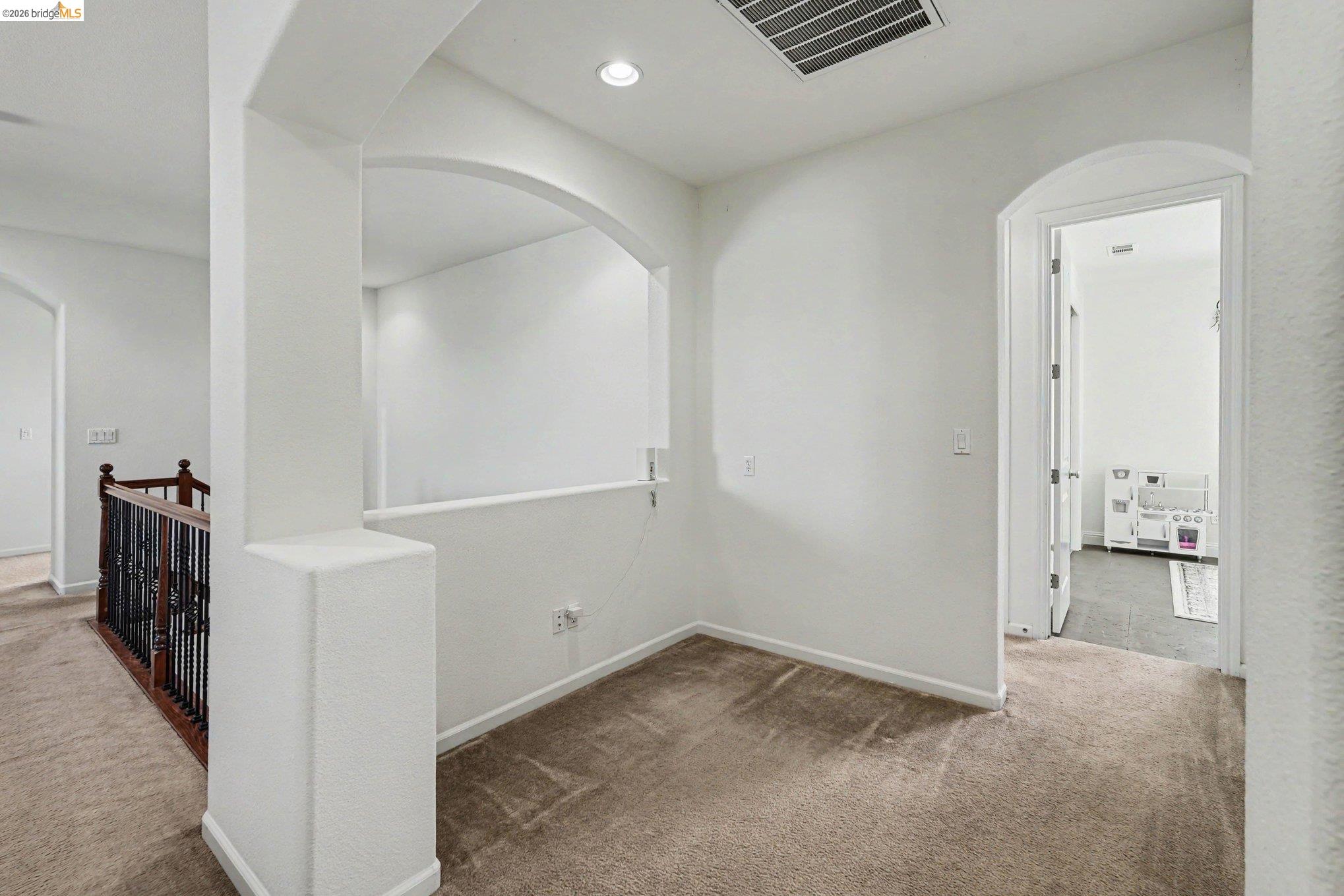 106 Little Ranch Circle Oakley, CA 94561 - Photo 17 of 34 Upper-level landing featuring neutral carpeting, recessed lighting, and an arched entryway
