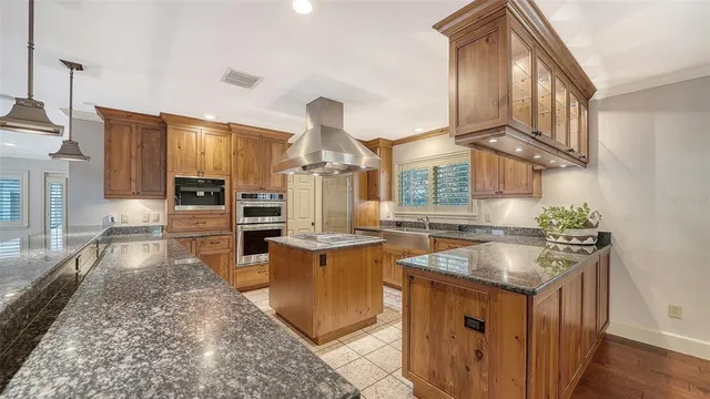 a kitchen with stainless steel appliances granite countertop a sink and a cabinets