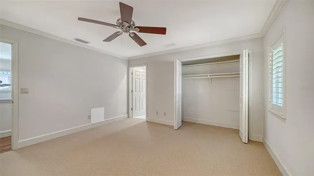 front view of a house with a yard and potted plants
