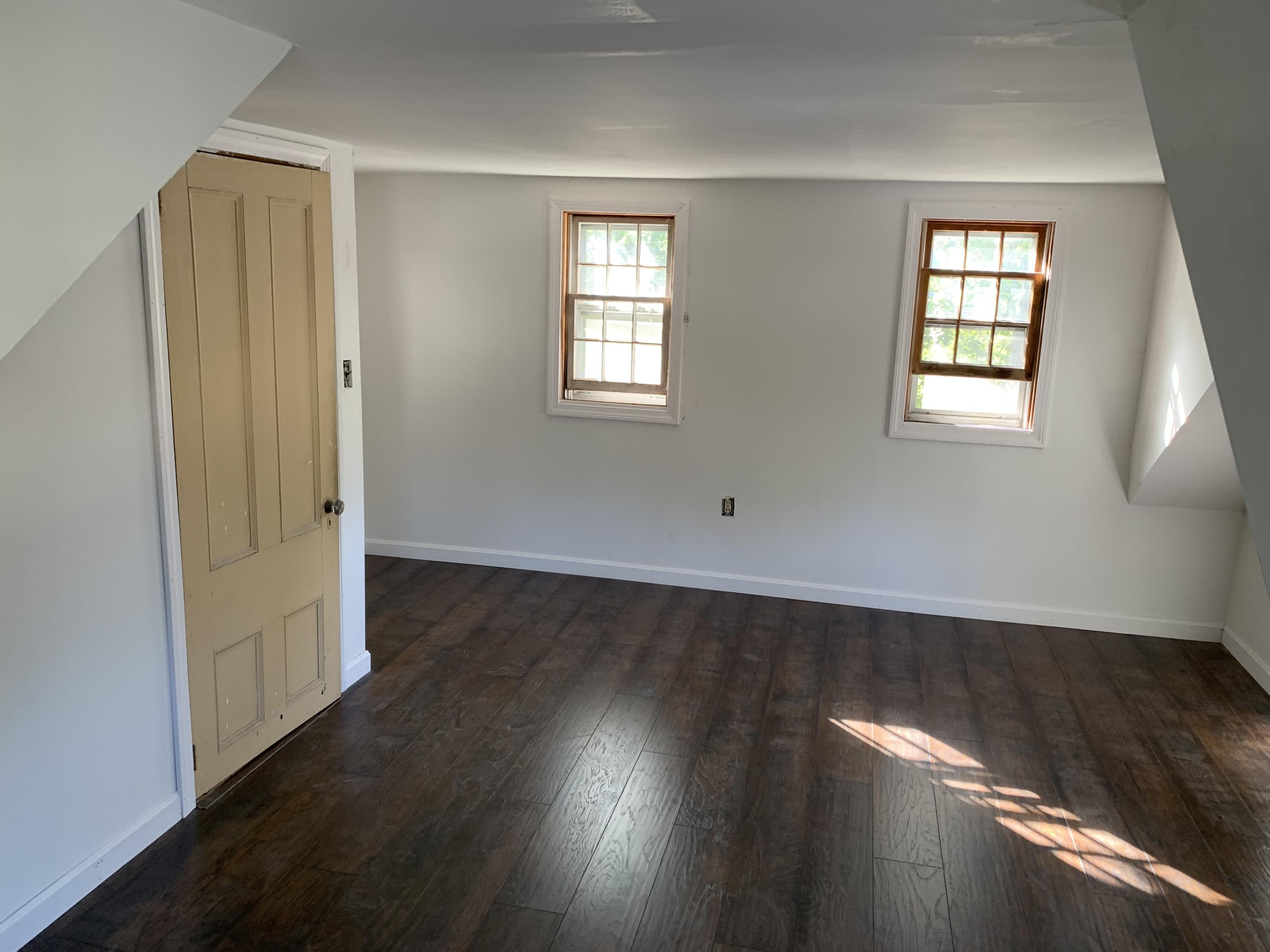 7 Brookshire Road Hyannis, MA 02601 - Photo 2 of 13 an empty room with wooden floor and windows