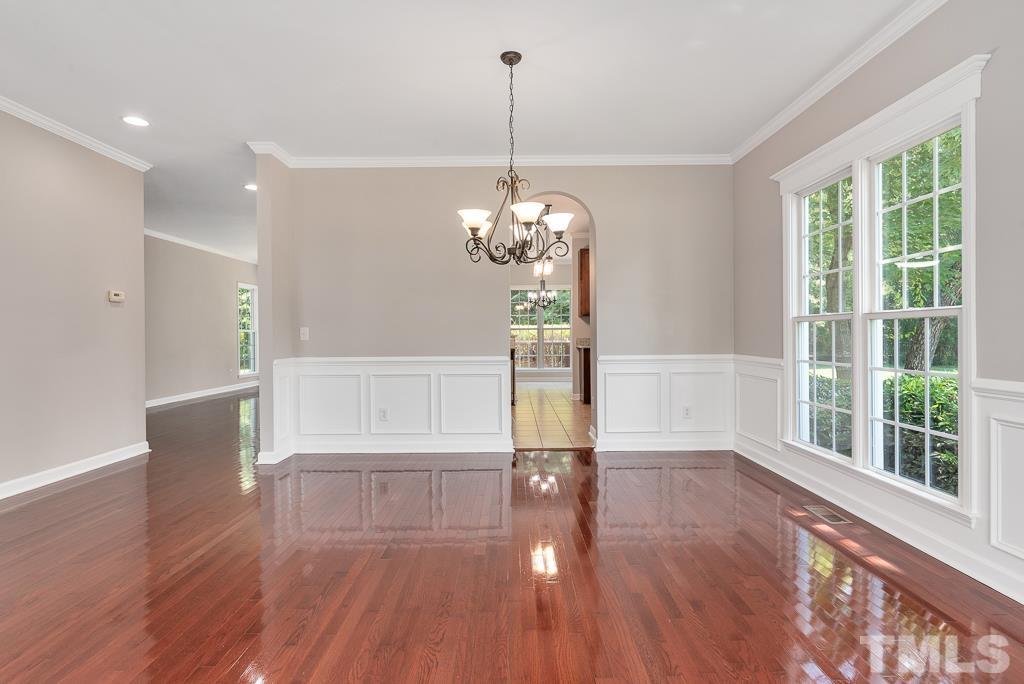 618 Red Cedar Circle Durham, NC 27712 - Photo 12 of 45 a view of a room with wooden floor chandelier and windows