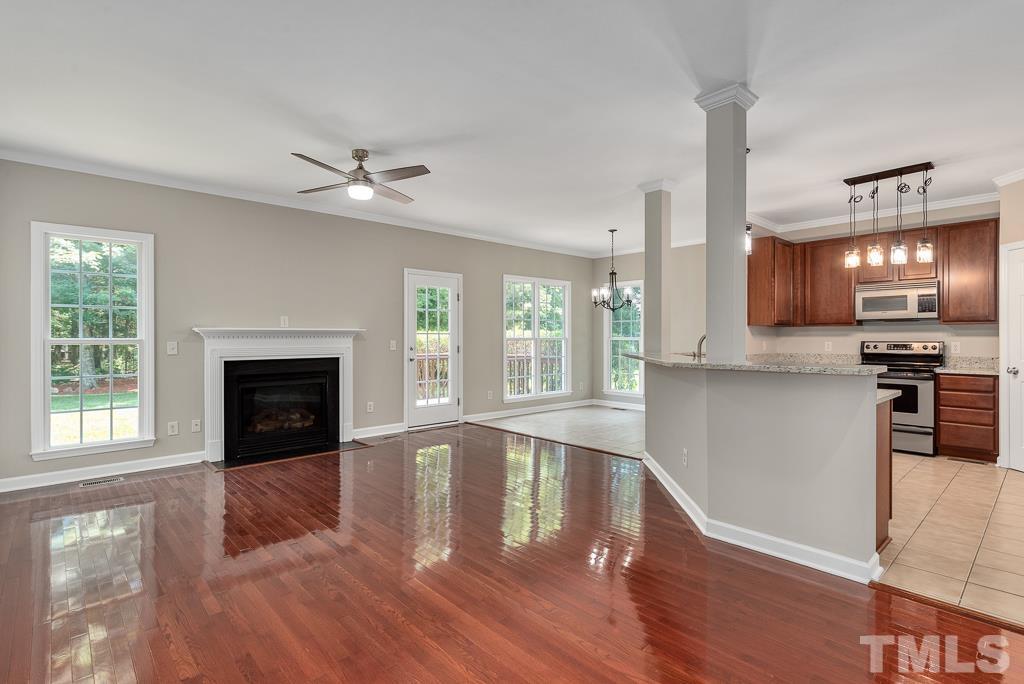 618 Red Cedar Circle Durham, NC 27712 - Photo 14 of 45 a view of an empty room with kitchen and a fireplace