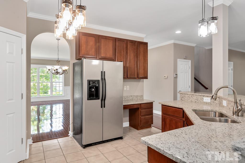 618 Red Cedar Circle Durham, NC 27712 - Photo 18 of 45 a kitchen with stainless steel appliances granite countertop a refrigerator a sink a stove and island