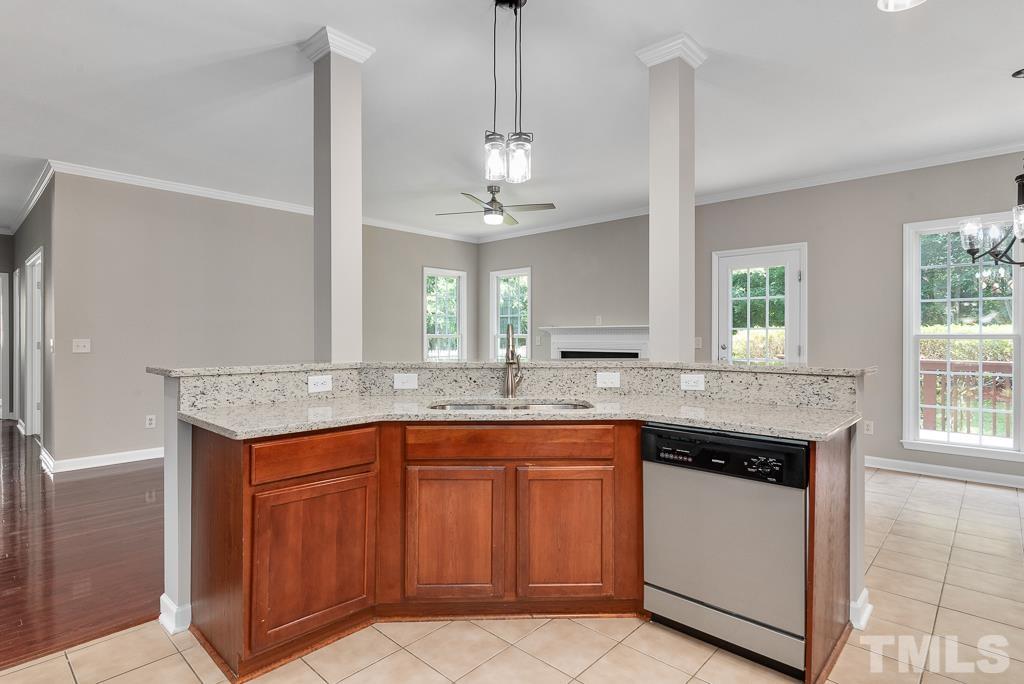 618 Red Cedar Circle Durham, NC 27712 - Photo 20 of 45 a kitchen with granite countertop stainless steel appliances a sink stove and cabinets