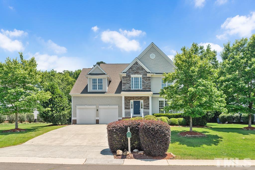 618 Red Cedar Circle Durham, NC 27712 - Photo 2 of 45 a front view of a house with a garden