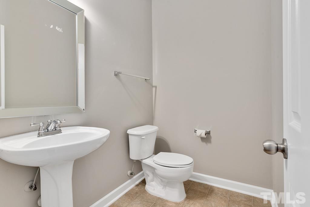 618 Red Cedar Circle Durham, NC 27712 - Photo 21 of 45 a bathroom with a toilet sink and mirror