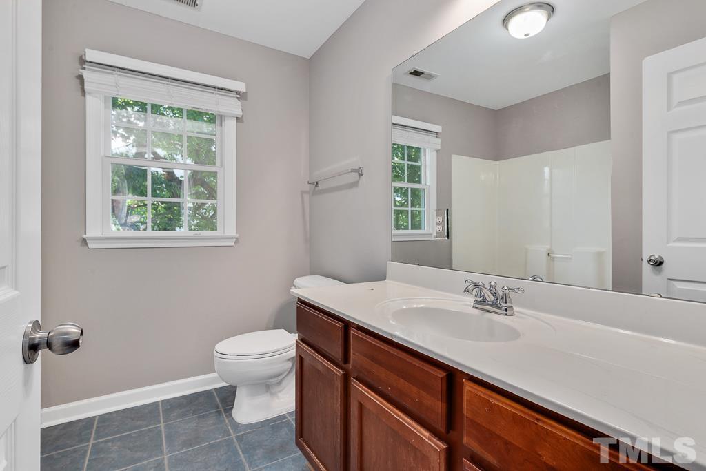 618 Red Cedar Circle Durham, NC 27712 - Photo 28 of 45 a bathroom with a sink vanity mirror and toilet