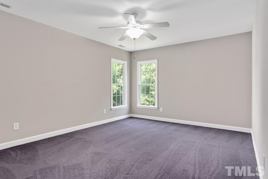 618 Red Cedar Circle Durham, NC 27712 - Photo 29 of 45 an empty room with windows and chandelier fan