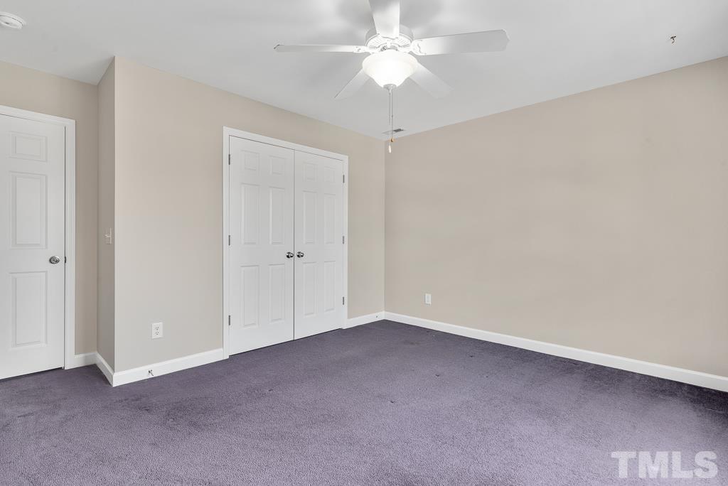 618 Red Cedar Circle Durham, NC 27712 - Photo 34 of 45 an empty room with a ceiling fan and a window