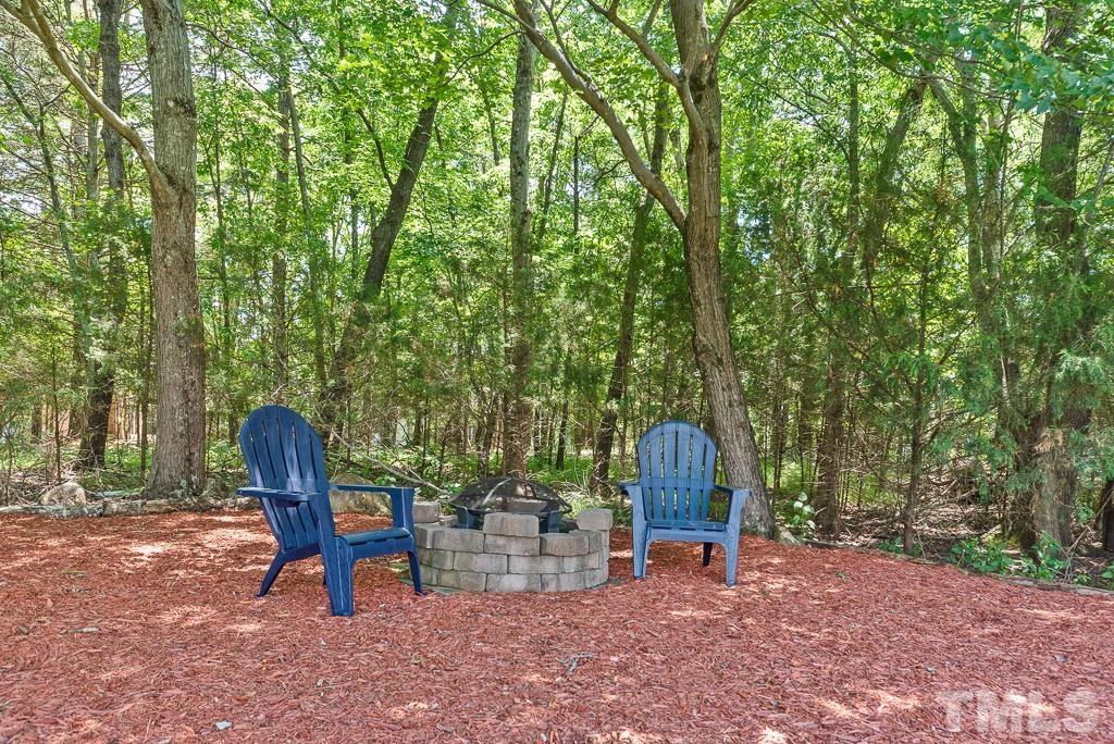 618 Red Cedar Circle Durham, NC 27712 - Photo 38 of 45 a backyard view with a table and chairs and a barbeque