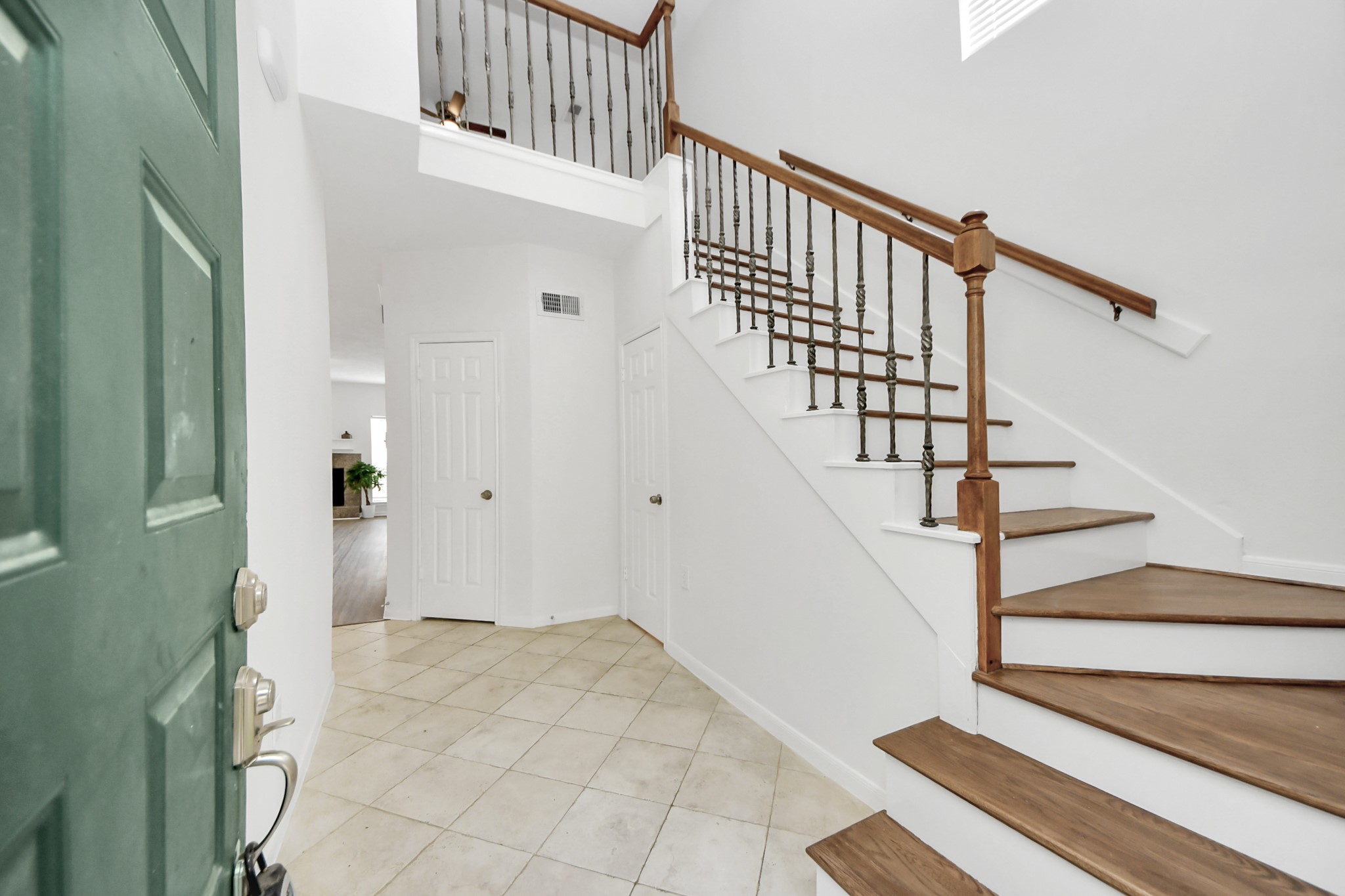 a view of entryway and hall with wooden floor