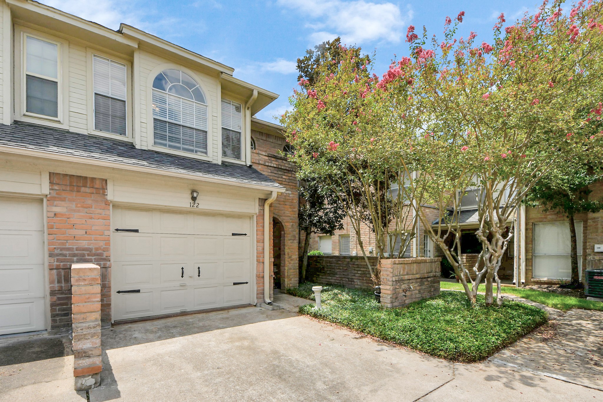 5515 Strack Road, Unit 122 Houston, TX 77069 - Photo 2 of 23 a front view of a house with a tree