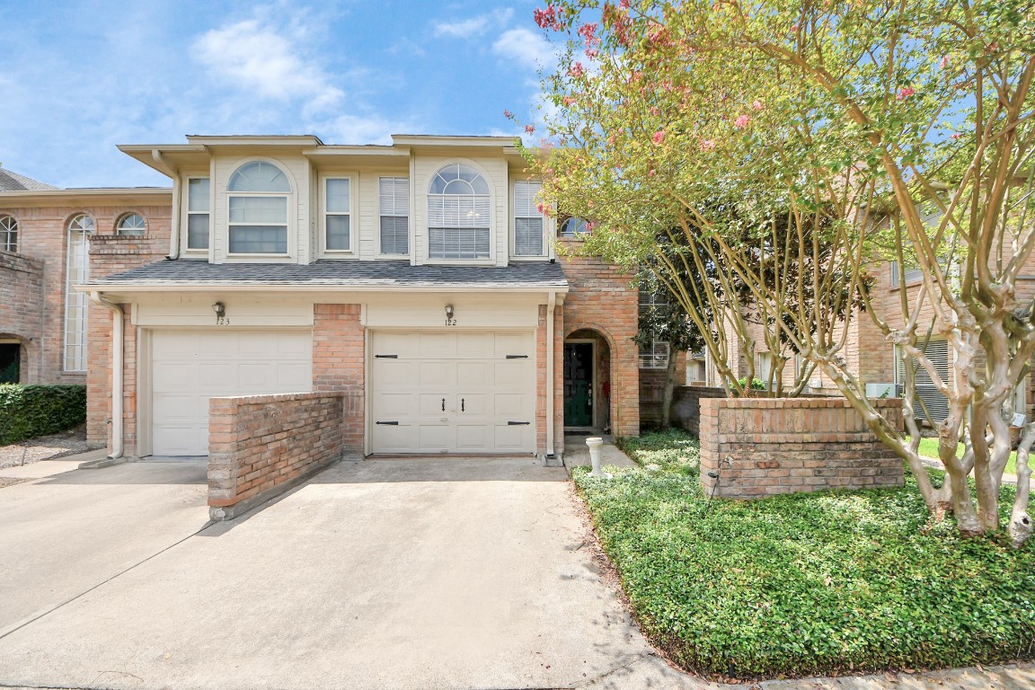 5515 Strack Road, Unit 122 Houston, TX 77069 - Photo 3 of 23 front view of a house with a large tree