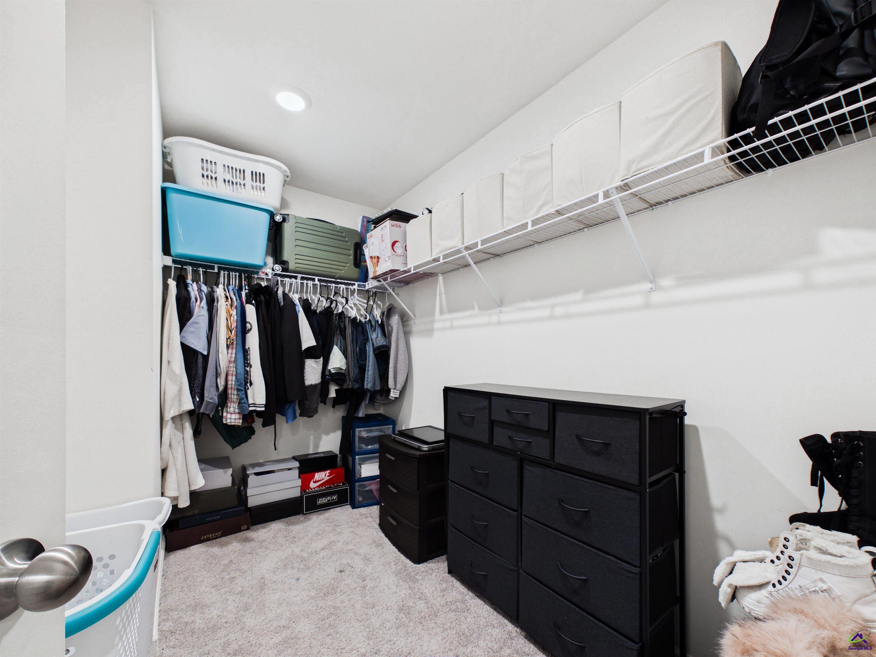 116 Jamie Court Fort Valley, GA 31030 - Photo 13 of 19 a view of walk in closet with clothes and shoes