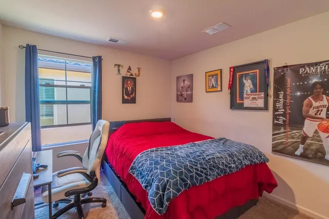 a bedroom with a bed and a dresser in it