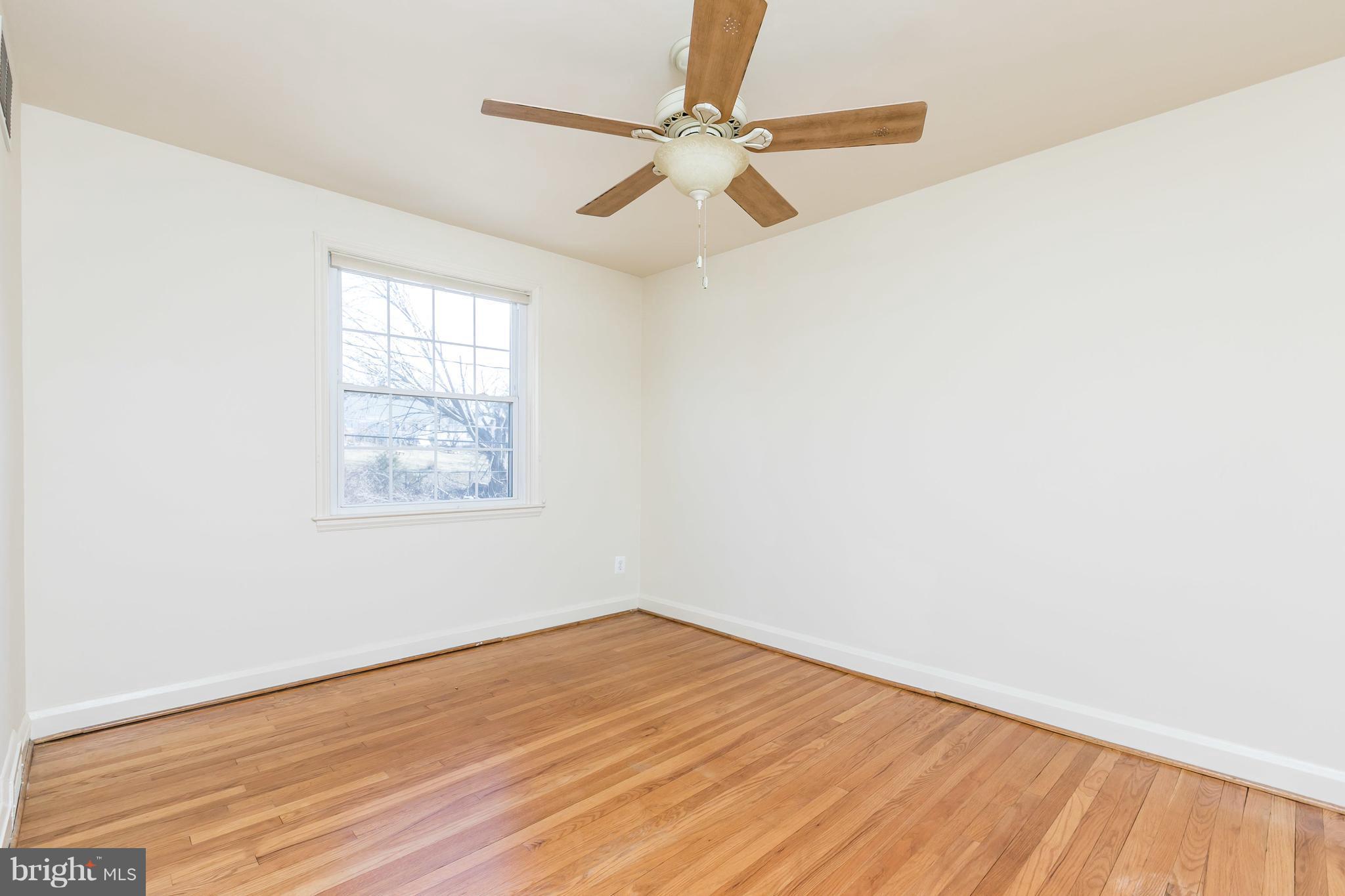 1872 Edgewood Road Towson, MD 21286 - Photo 11 of 17 an empty room with wooden floor fan and windows