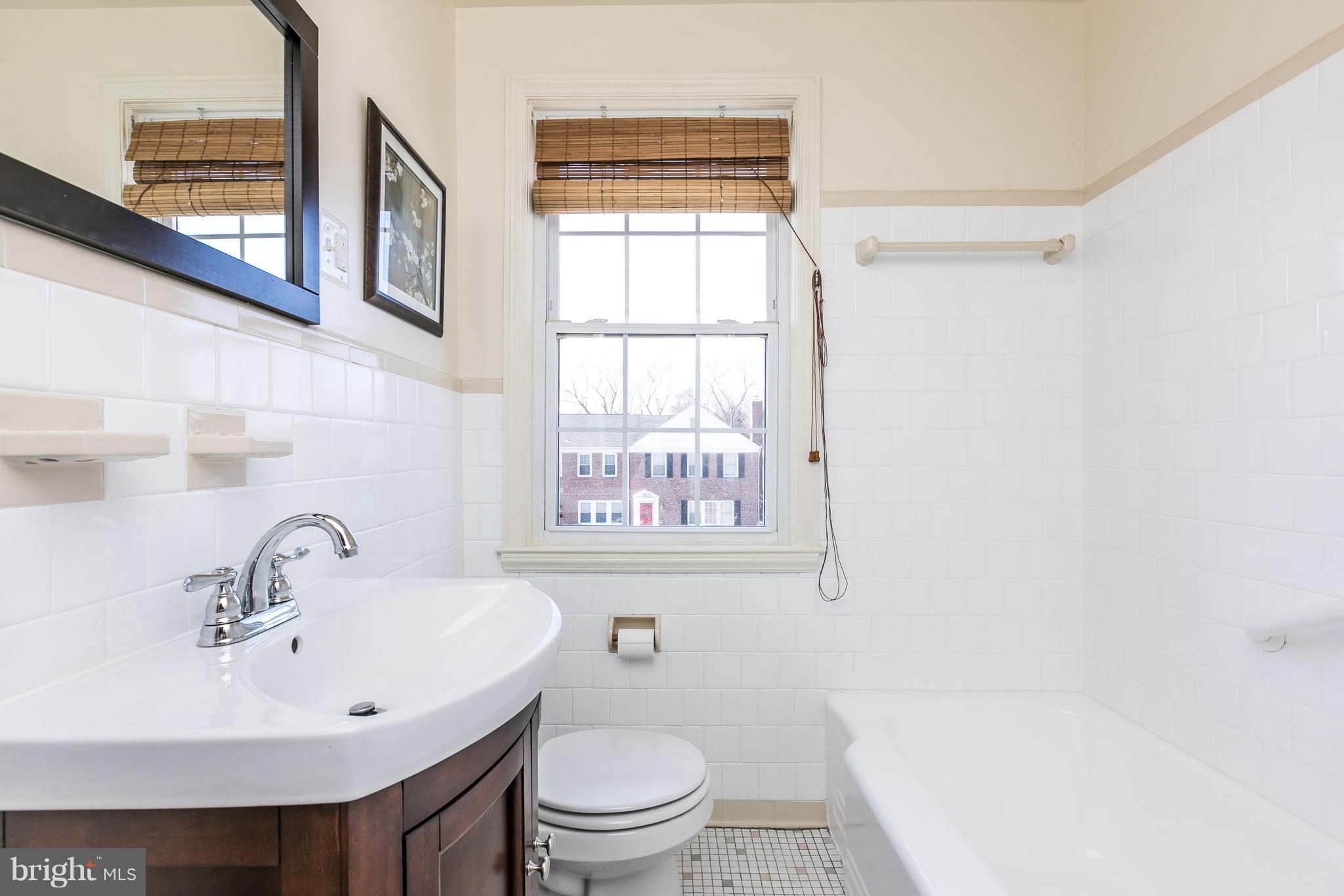 1872 Edgewood Road Towson, MD 21286 - Photo 13 of 17 a bathroom with a sink a mirror and a toilet