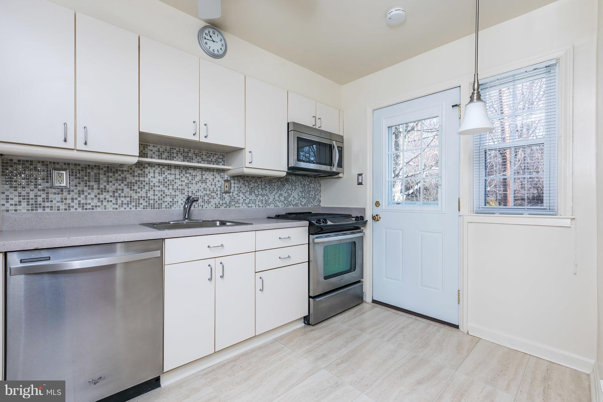 1872 Edgewood Road Towson, MD 21286 - Photo 5 of 17 a kitchen with stainless steel appliances granite countertop a stove a sink and a refrigerator