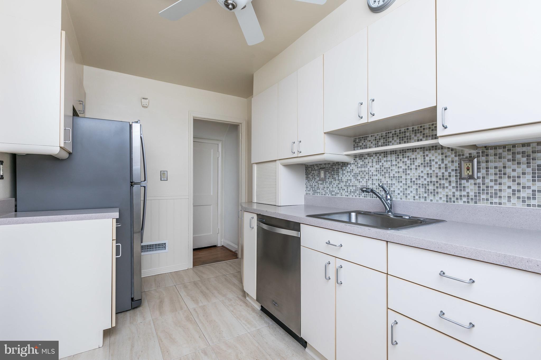 1872 Edgewood Road Towson, MD 21286 - Photo 6 of 17 a kitchen with white cabinets and stainless steel appliances