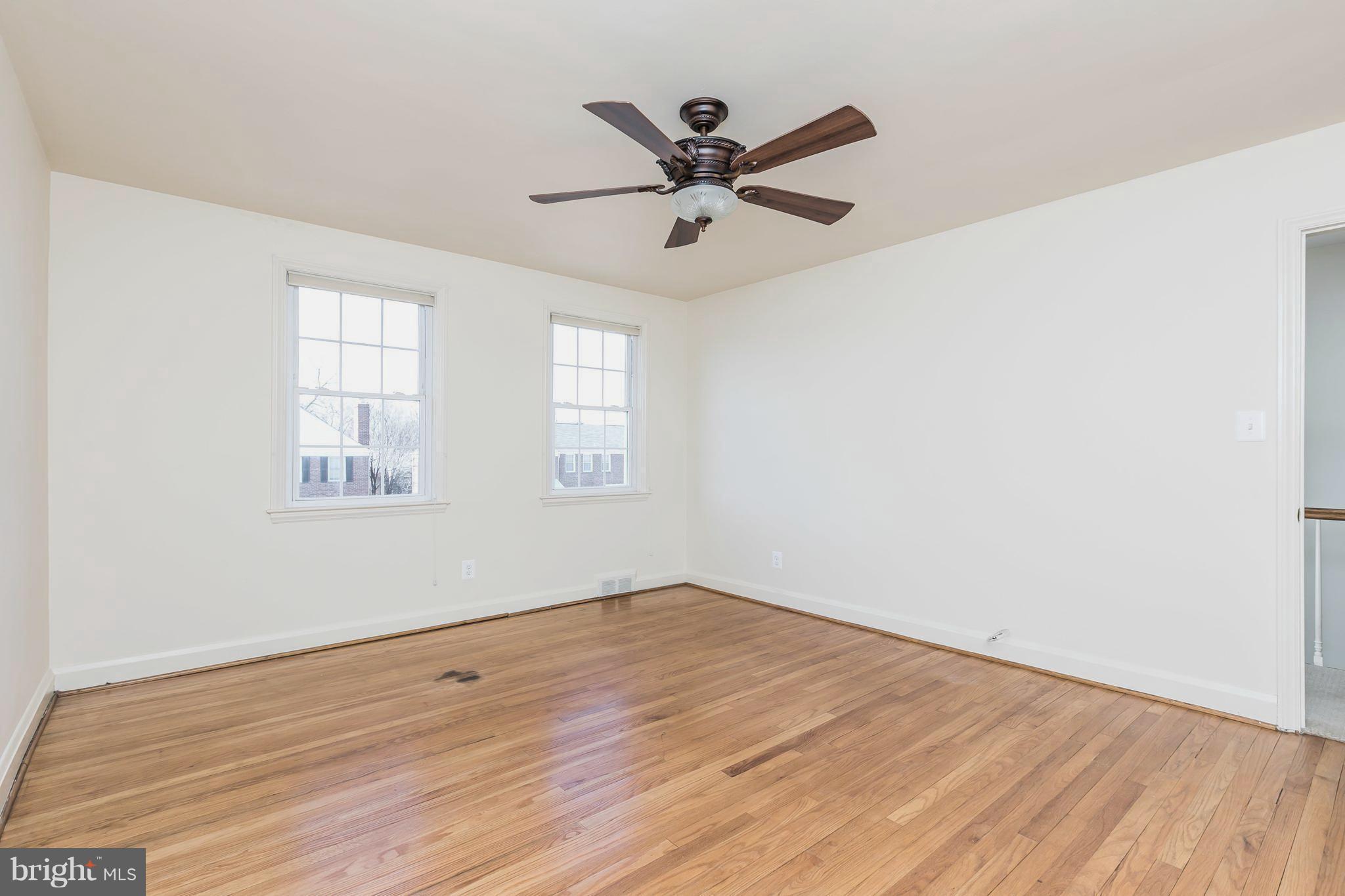 1872 Edgewood Road Towson, MD 21286 - Photo 10 of 17 an empty room with wooden floor fan and windows