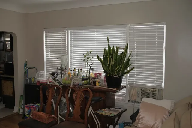 a dining room with furniture and a flat screen tv