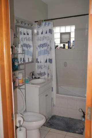 a bathroom with a shower and a sink
