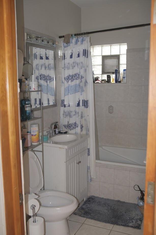 1651 West 79th Street Chicago, IL 60620 - Photo 17 of 29 a bathroom with a granite countertop sink a toilet and shower