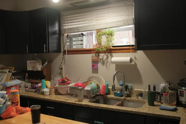 a kitchen with refrigerator and cabinets