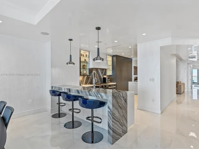 a kitchen with stainless steel appliances granite countertop a refrigerator and a stove