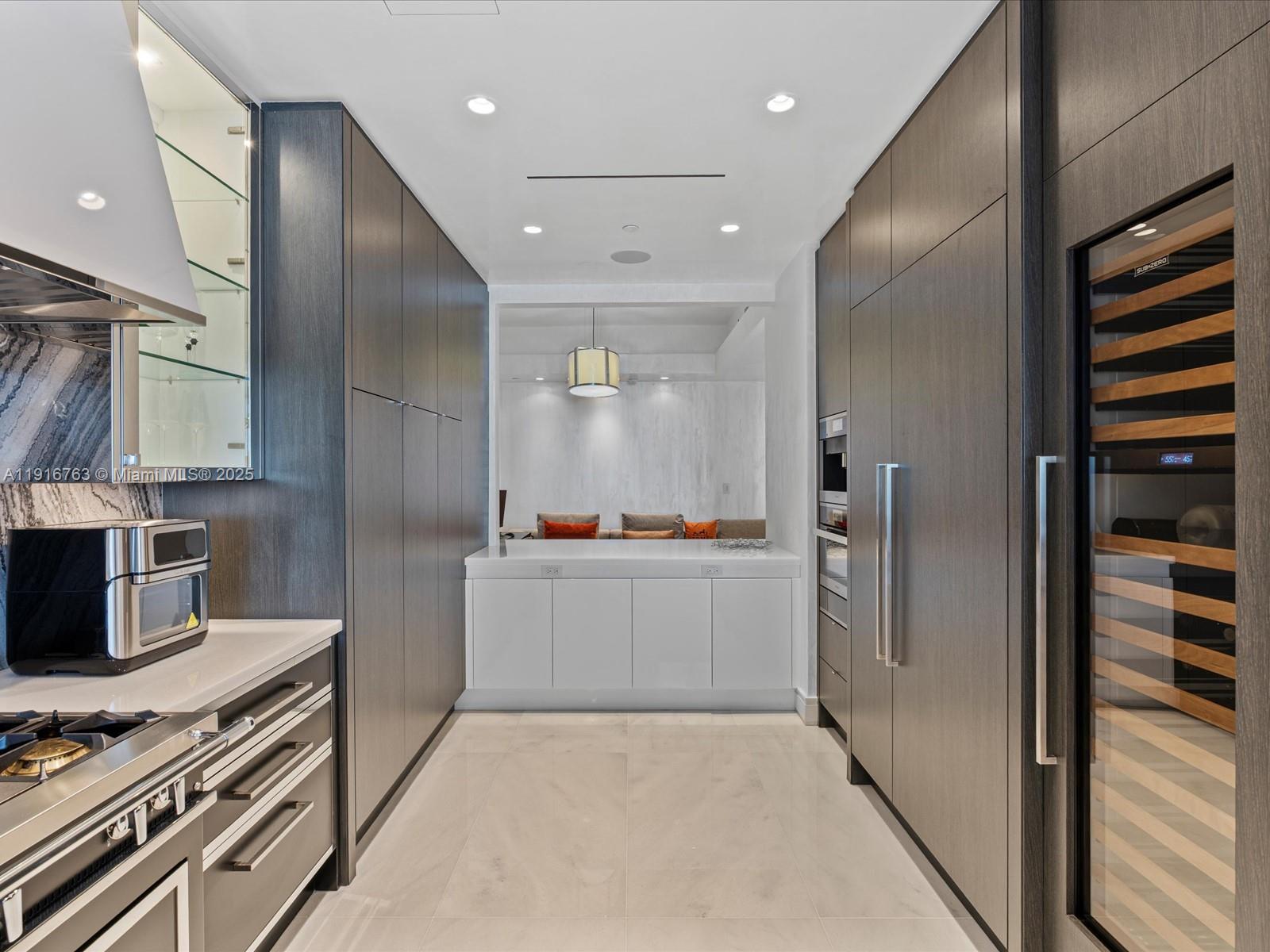 17901 Collins Avenue, Unit 2602 Sunny Isles Beach, FL 33160 - Photo 15 of 85 a large kitchen with stainless steel appliances a refrigerator and a stove top oven