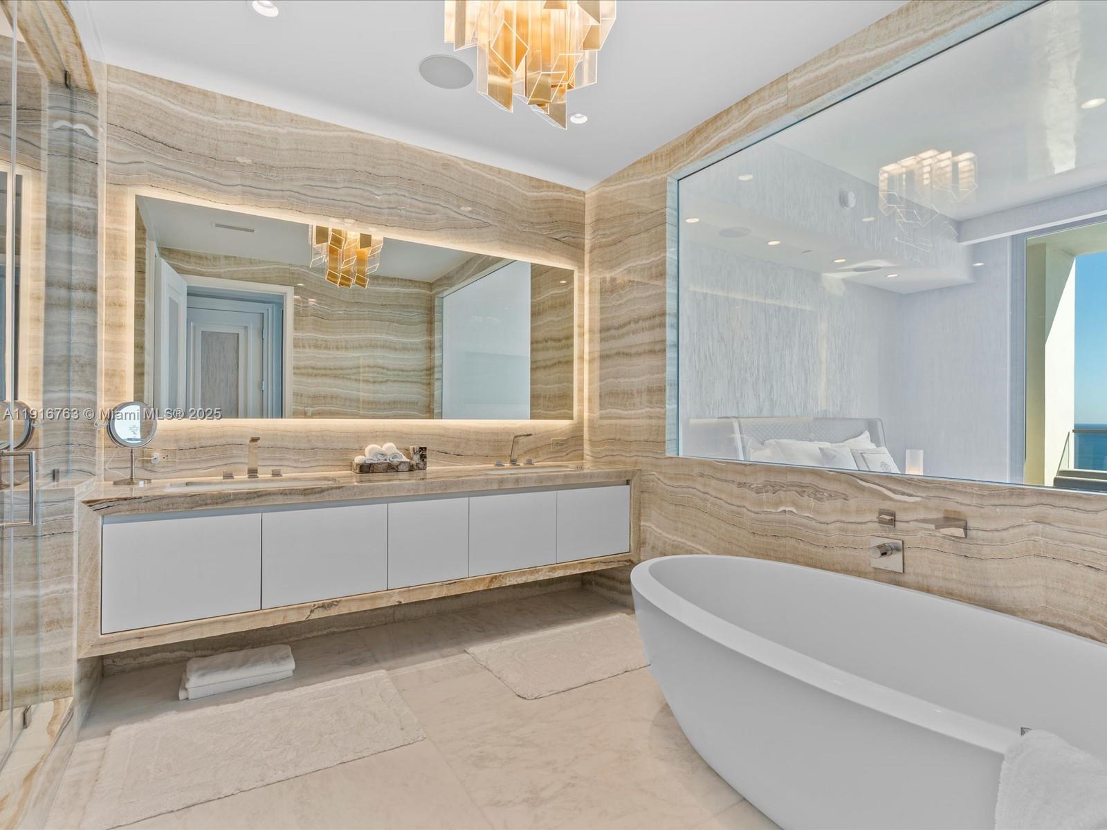 17901 Collins Avenue, Unit 2602 Sunny Isles Beach, FL 33160 - Photo 24 of 85 a bathroom with a double vanity sink mirror and bathtub