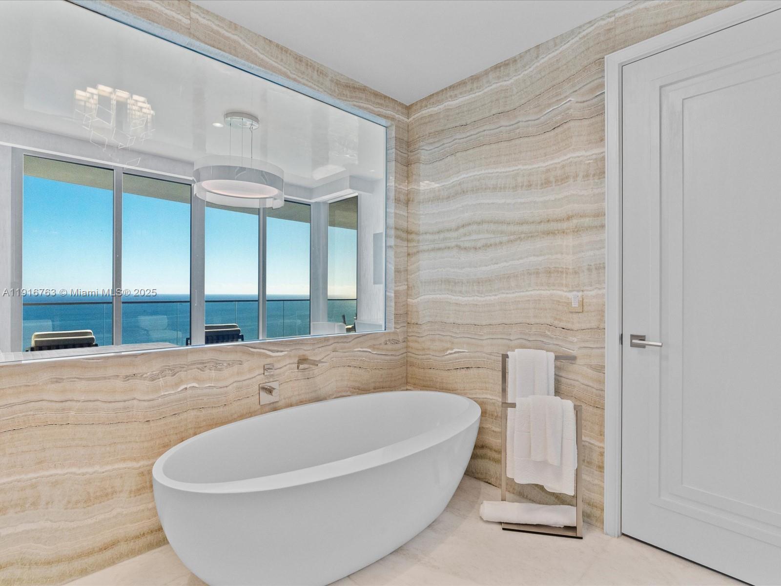 17901 Collins Avenue, Unit 2602 Sunny Isles Beach, FL 33160 - Photo 26 of 85 a white bath tub sitting in a bathroom
