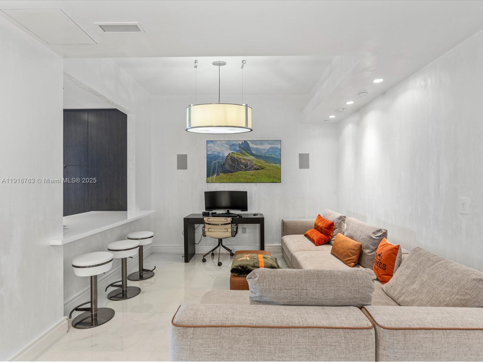 17901 Collins Avenue, Unit 2602 Sunny Isles Beach, FL 33160 - Photo 36 of 85 a living room with furniture and a chandelier