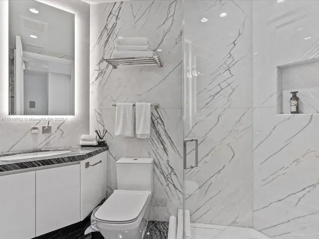 a bedroom with a large bed and a fireplace