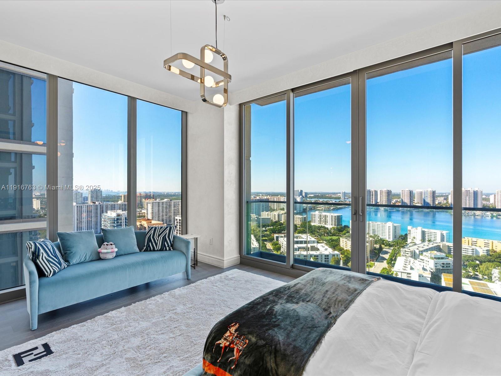 17901 Collins Avenue, Unit 2602 Sunny Isles Beach, FL 33160 - Photo 54 of 85 a spacious bedroom with a large bed and a large window