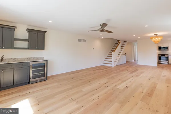 a view of a kitchen with microwave and a sink