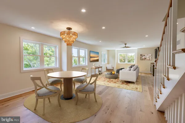 a living room with fireplace furniture and a large window