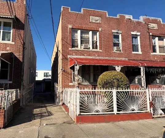 a front view of a house with iron fence