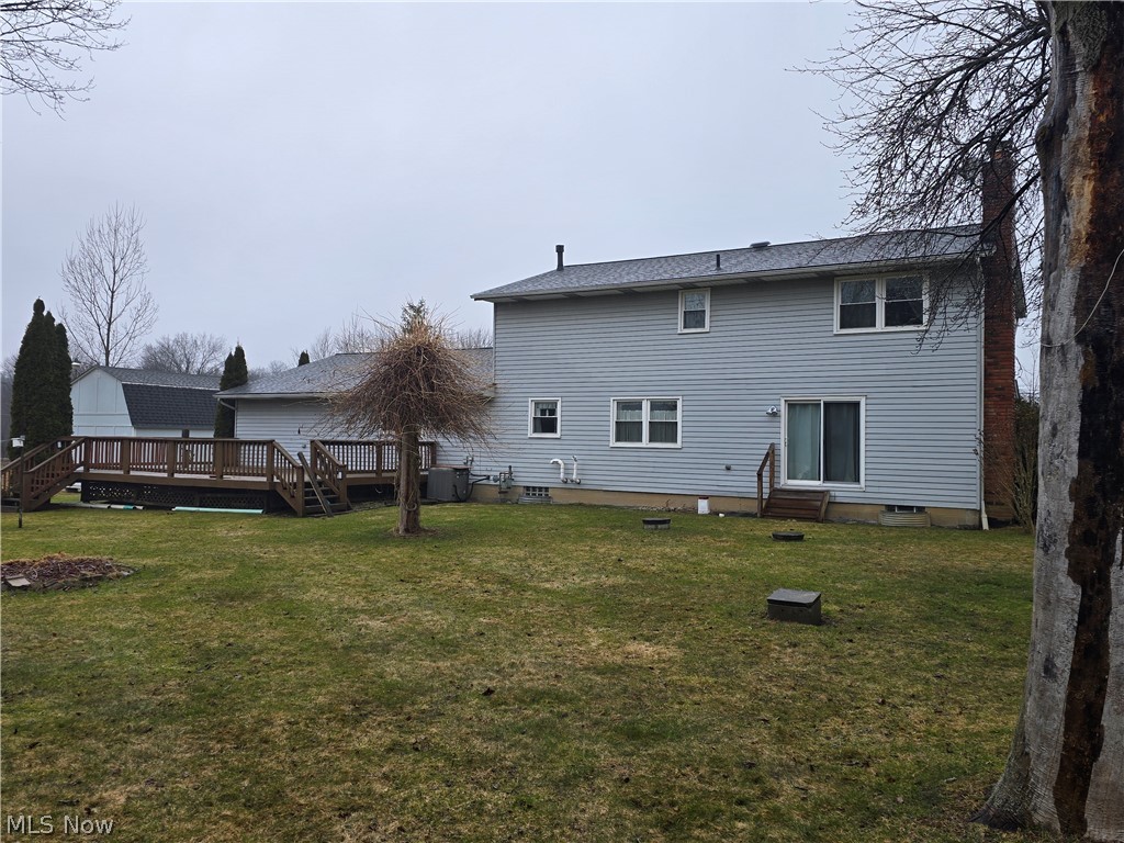 2672 Crackel Road Aurora, OH 44202 - Photo 13 of 38 Rear view of house featuring a yard and a wooden deck