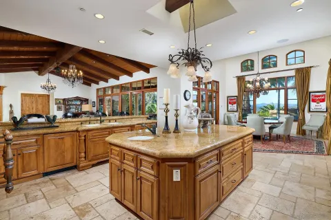 a kitchen with stainless steel appliances granite countertop a sink and a refrigerator