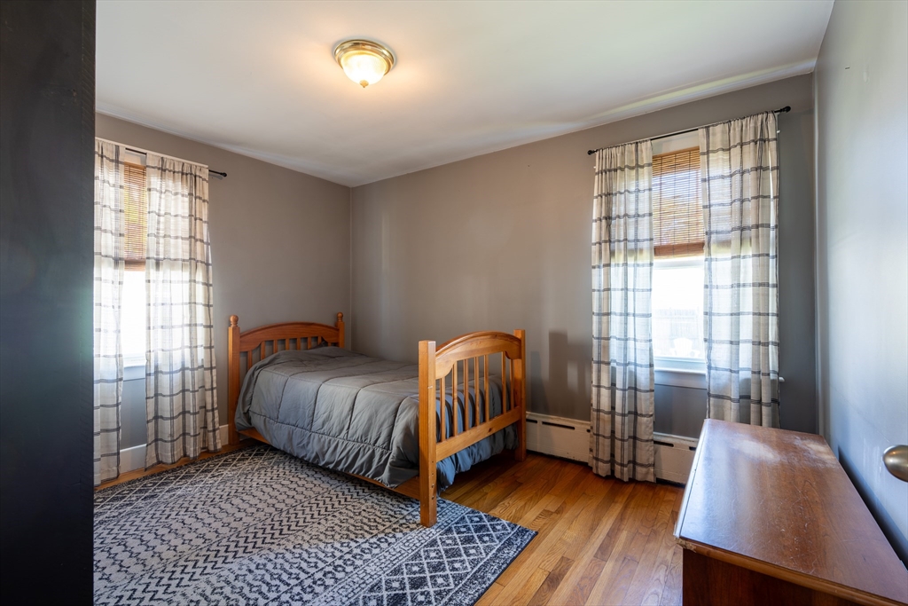 110 James M Beardsworth Road Tiverton, RI 02878 - Photo 10 of 26 a bedroom with a bed and wooden floor