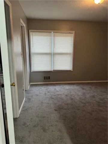 an empty room with a empty space and window