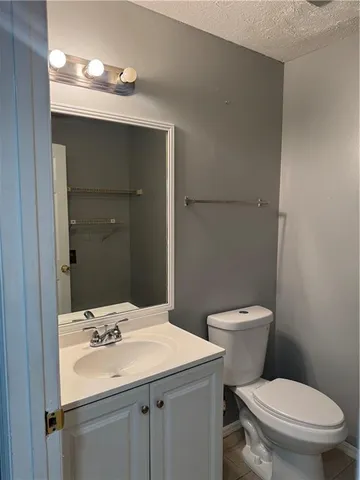 a bathroom with a sink toilet and mirror