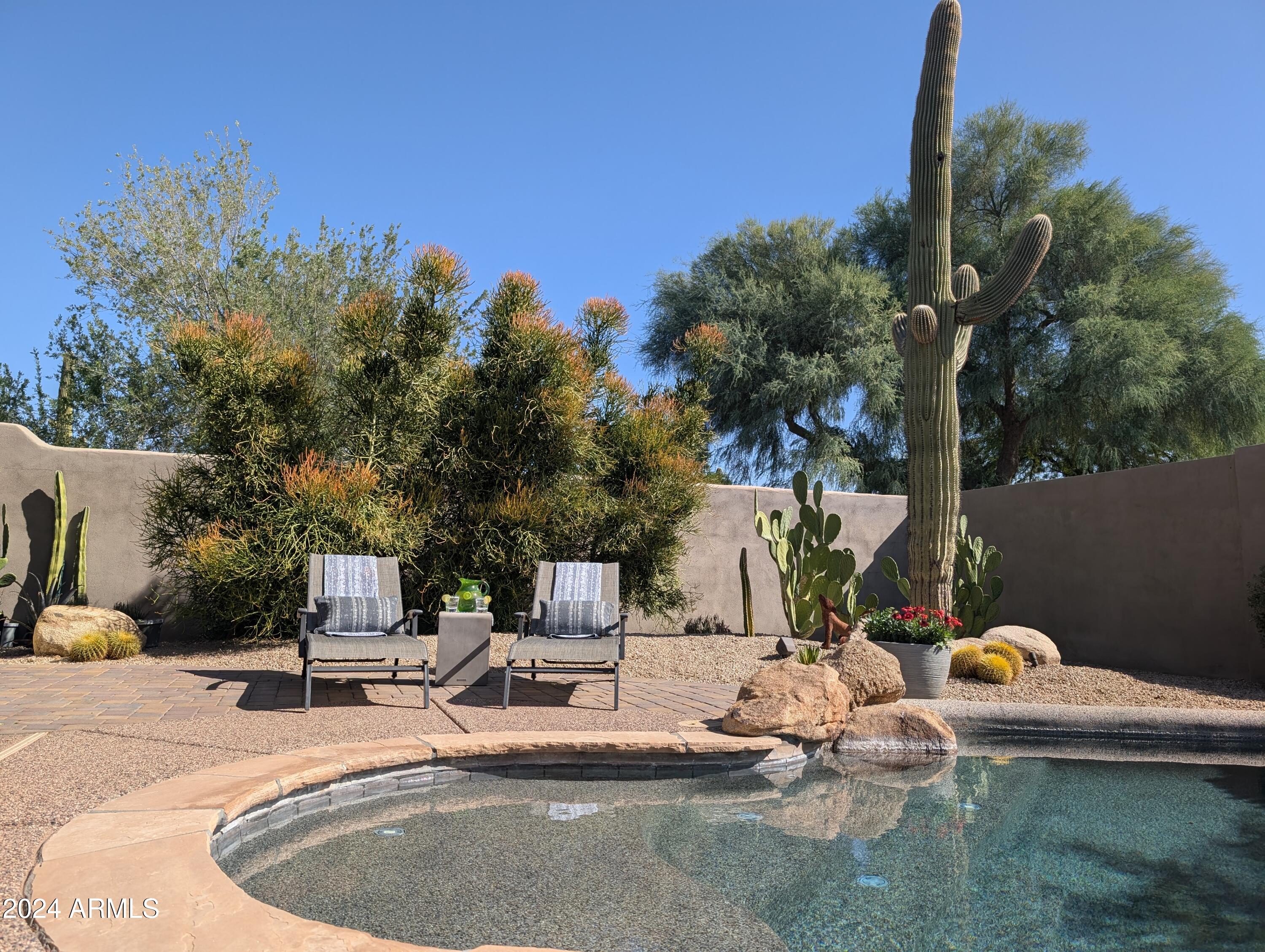 7953 East Thunderhawk Road Scottsdale, AZ 85255 - Photo 1 of 40 a view of swimming pool with a patio and fire pit
