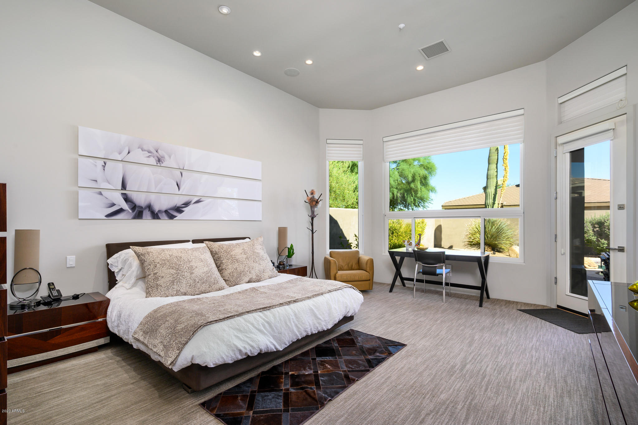 7953 East Thunderhawk Road Scottsdale, AZ 85255 - Photo 19 of 40 a bedroom with a bed and wooden floor