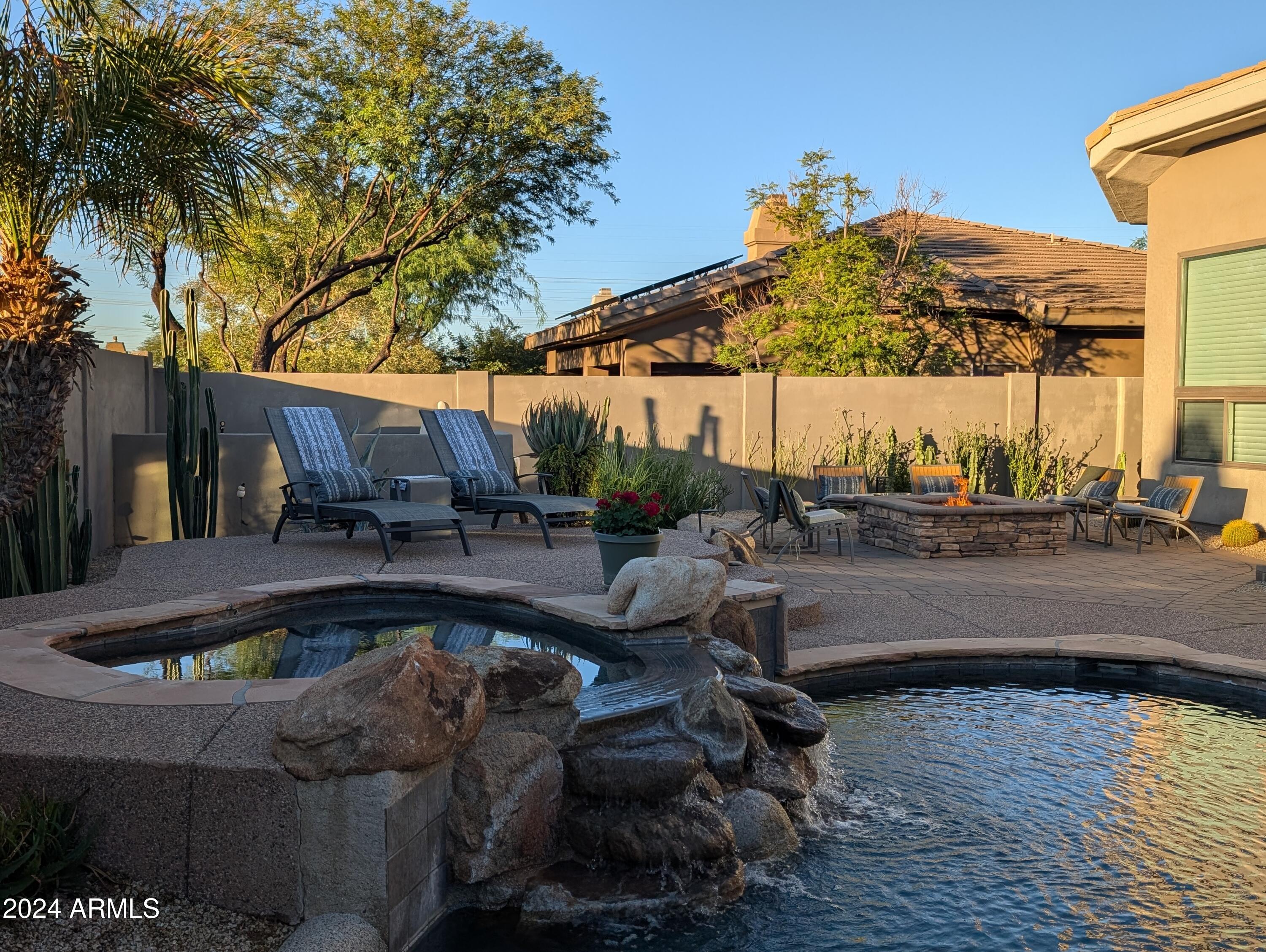 7953 East Thunderhawk Road Scottsdale, AZ 85255 - Photo 35 of 40 a view of patio with swimming pool table and chairs